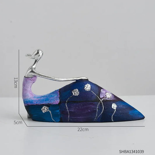 Statue of a woman sitting in a blue/purple skirt